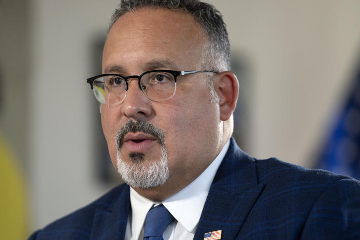 Education Secretary Miguel Cardona speaks during an interview with The Associated Press in his office at the Department of Education, Sept. 20, 2023, in Washington, D.C.