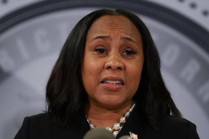 Fulton County District Attorney Fani Willis speaks during a news conference in Atlanta on Aug. 14.