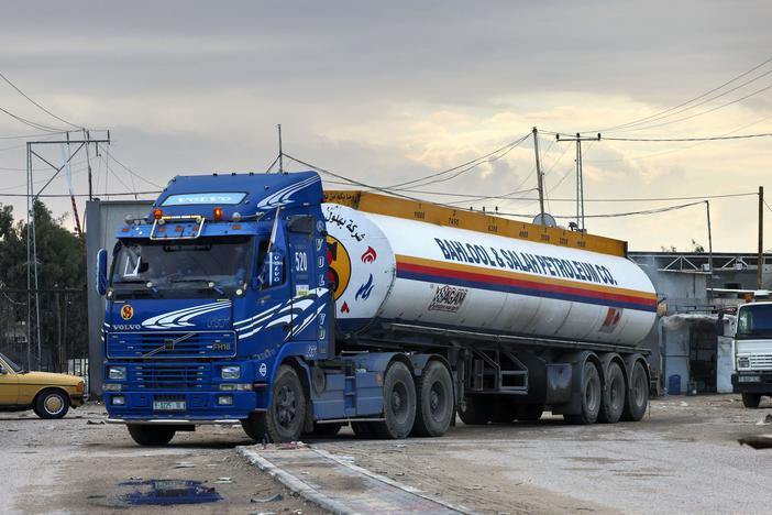A truck carrying a limited delivery of fuel crosses into Rafah in the southern Gaza Strip on Wednesday. Israel has agreed to allow in a greater amount of fuel for humanitarian use.