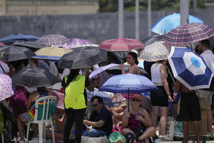 Taylor Swift fans wait for the doors of Nilton Santos Olympic stadium to open for her Eras Tour concert amid a heat wave in Rio de Janeiro, Brazil, Saturday, Nov. 18, 2023. A 23-year-old Taylor Swift fan died Friday night after suffering from cardiac arrest due to heat at the concert, according to a statement from the show's organizers in Brazil.