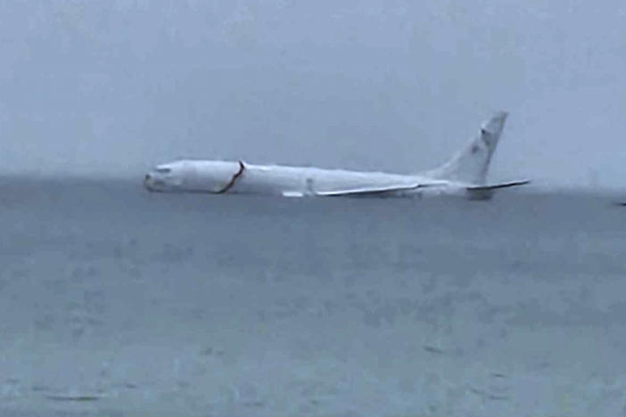 This photo provided by Diane Dircks shows a U.S. Navy plane that overshot a Marine base on Kaneohe Bay, Hawaii, Monday, Nov. 20, 2023. An official says all nine people aboard the plane have escaped injury.