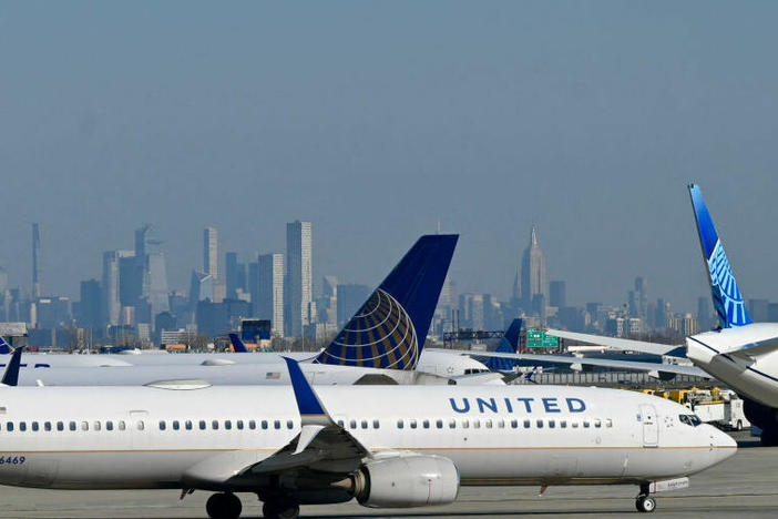 United Air Lines planes line up along the busy Newark Liberty International Airport, New Jersey, on the eve of Thanksgiving on November 23, 2022.