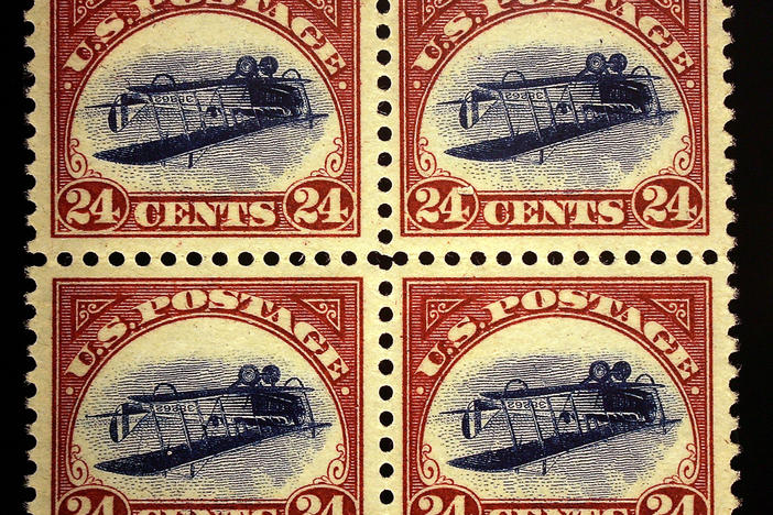 An enlarged replica of a block of four rare United States airmail error stamps, known as the Inverted Jenny plate block.