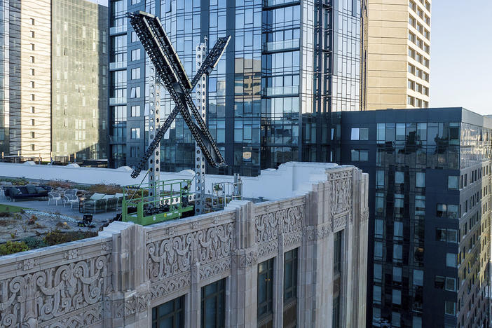 An "X" sign rests atop the company headquarters in downtown San Francisco, on July 28, 2023.
