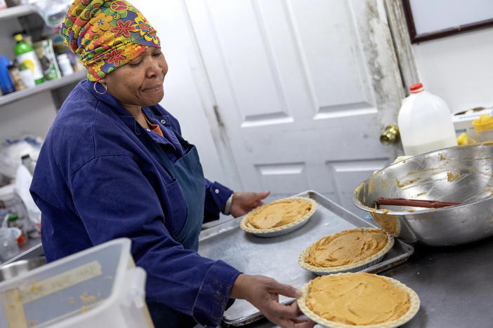 Pastry chef Carla Jones loads a trio of sweet potato pies onto a tray destined for the oven on Nov. 15 at Ol' Henry, a restaurant in Berkeley, Mo.