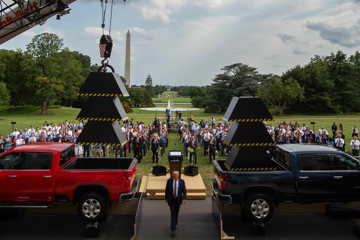 Then-President Donald Trump walks past weights and a crane after delivering remarks at the White House in July 2020.