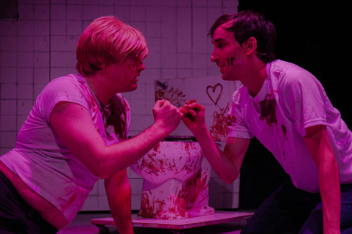 Andrew Caira (left) and Adam Parbhoo (right) star in a performance of <em>Saw the Musical: The Unauthorized Parody of Saw</em> at Manhattan's AMT theater.