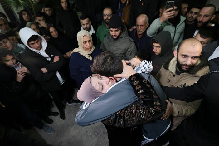 Palestinian prisoner Khalil Zama, right, hugs his mother after being released from an Israeli jail in exchange for Israeli hostages released by Hamas from the Gaza Strip, at his home in Halhul village north Hebron in the occupied West Bank on Monday.