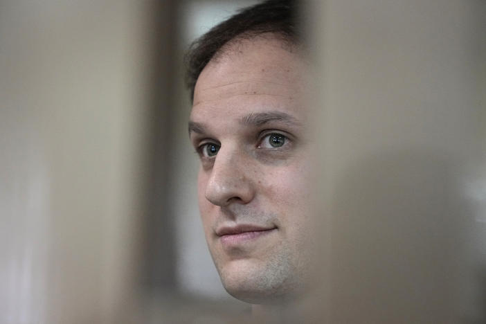 <em>Wall Street Journal</em> reporter Evan Gershkovich stands in a glass cage in a courtroom at the Moscow City Court in Moscow, on Oct. 10. A court in Moscow on Tuesday extended his detention until Jan. 30, Russian news agencies reported.