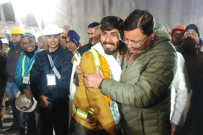 Pushkar Singh Dhami (right), chief minister of Uttarakhand state, greeting a worker rescued from the site of the collapsed tunnel.
