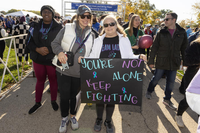 Participants walk in support and in memory of those lost, during American Foundation for Suicide Prevention Out of the Darkness Chicagoland Walk at Montrose Harbor on October 21, 2023 in Chicago, Illinois.