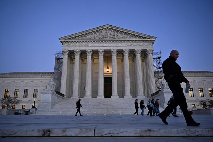 People walk past the U.S. Supreme Court in Washington, D.C., earlier this month.