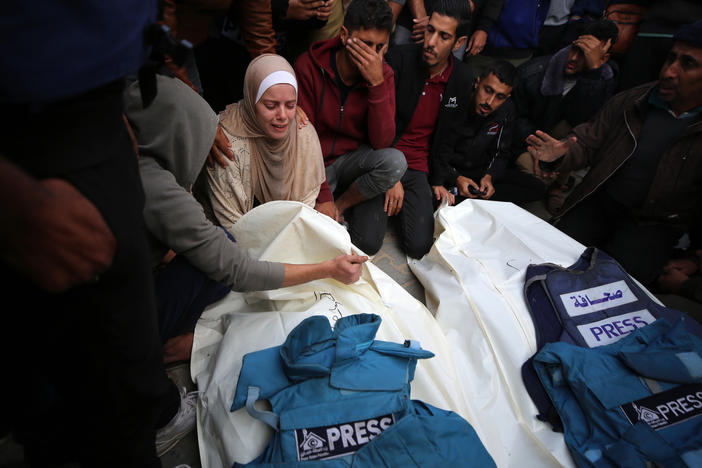 Journalists, relatives and friends pray over the bodies of journalists Sari Mansour and Hassouna Esleem after they were killed in an Israeli bombardment at Bureij camp in the central Gaza Strip on Nov. 19.