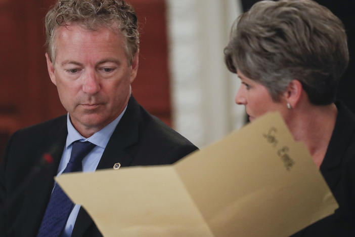 Sen. Rand Paul, R-Ky., performed the Heimlich maneuver on Sen. Joni Ernst, R-Iowa as she was choking Thursday during a closed-door GOP lunch. Here, Paul and Ernst look over a folder provided to them by the White House, during a luncheon in 2017 in the State Dinning Room of the White House.