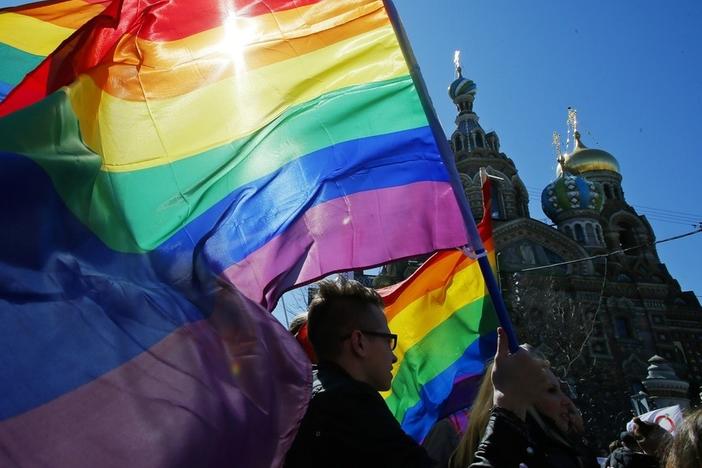 Gay rights activists carry rainbow flags as they march during a May Day rally in 2013 in St. Petersburg, Russia. Russia's Supreme Court on Thursday effectively outlawed LGBTQ+ activism, in the most drastic step against advocates of gay, lesbian and transgender rights in the increasingly conservative country.