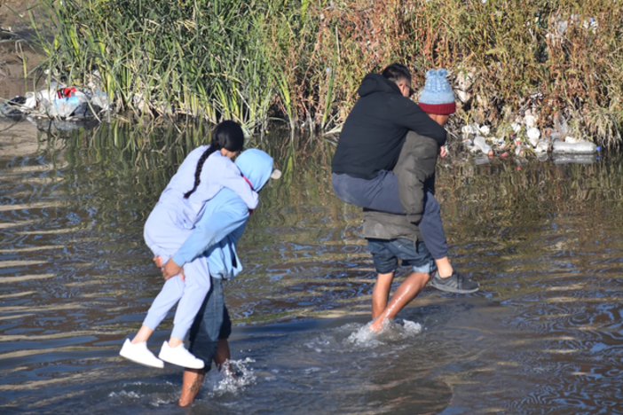 Migrants cross the Rio Grande from Mexico near El Paso, Texas. A new law makes illegal entry into Texas from a foreign country a state crime. It also authorizes a state judge to order someone to return to Mexico after their arrest.