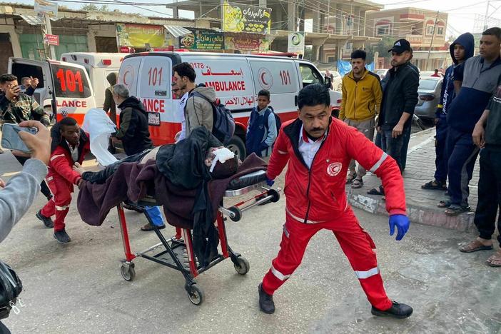 Workers rush injured people to Mohammed Yousef al-Najjar Hospital in Rafah as Israel resumed its bombing Friday morning in the Gaza Strip.