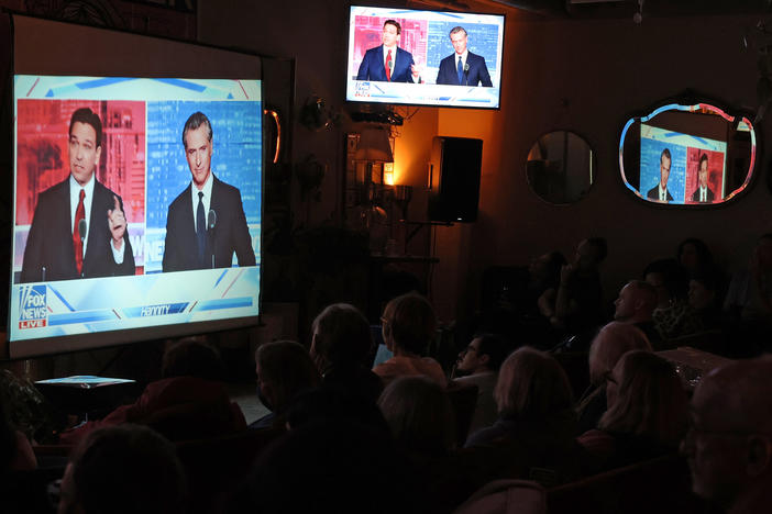 People gather in San Francisco to watch a debate on Fox News between California Gov. Gavin Newsom and Florida Gov. Ron DeSantis.