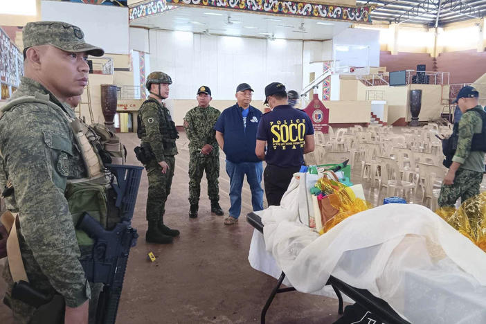 In this handout photo provided by the Provincial Government of Lanao Del Sur - Public Information Office, law enforcers conduct an investigation at the site of an explosion in Marawi city, southern Philippines on Sunday Dec. 3, 2023.