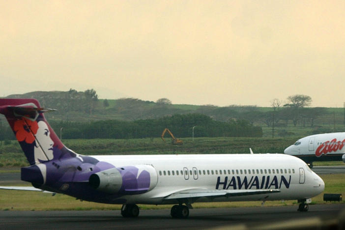 An Hawaiian Airlines plane taxis for position at Kahalui, Hawaii, on the island of Maui, March 24, 2005. Alaska Air Group said Sunday that it agreed to buy Hawaiian Airlines.