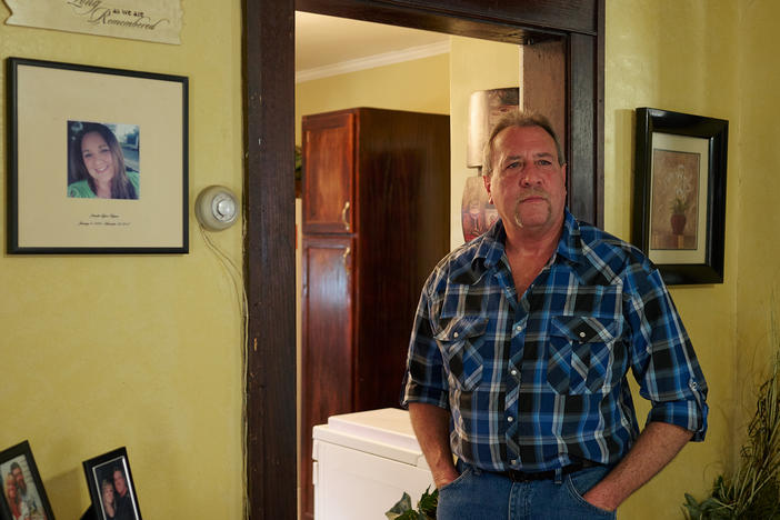 Ernie Haynes stands next to a memorial for his daughter, Jennifer, at his home in Risingsun, Ohio. Following her drug overdose death in 2017, he was charged with abduction after trying to gain custody of his grandchildren. The action sparked a five-year legal battle to clear his name.