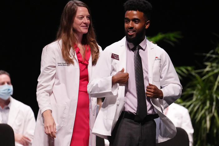 People of color who have a doctor who looks like them report more satisfaction with their health care. Here, Abel Woldu and Dr. Kelsey Angell participate in the University of Minnesota's white coat ceremony in 2022. Half of that incoming class of doctors-in-training are people of color.