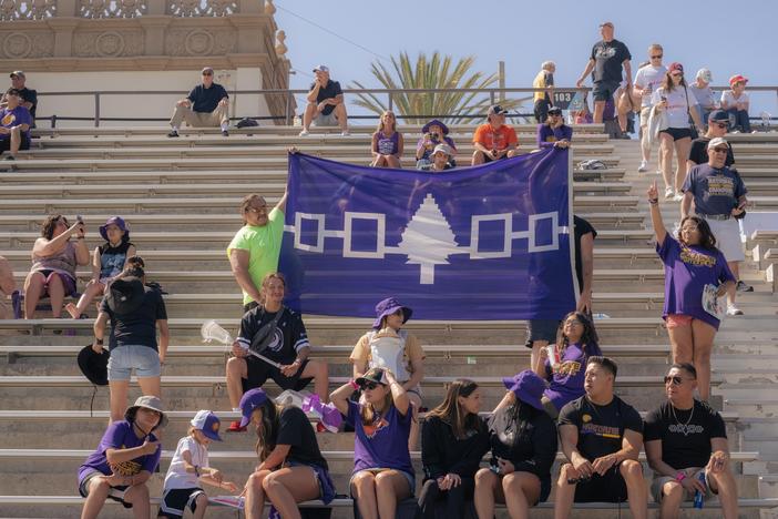 Supporters hold up a banner displaying the Haudenosaunee Confederacy as they cheer for the Haudenosaunee Nationals during a July 23, 2023 match against England in San Diego, Calif.