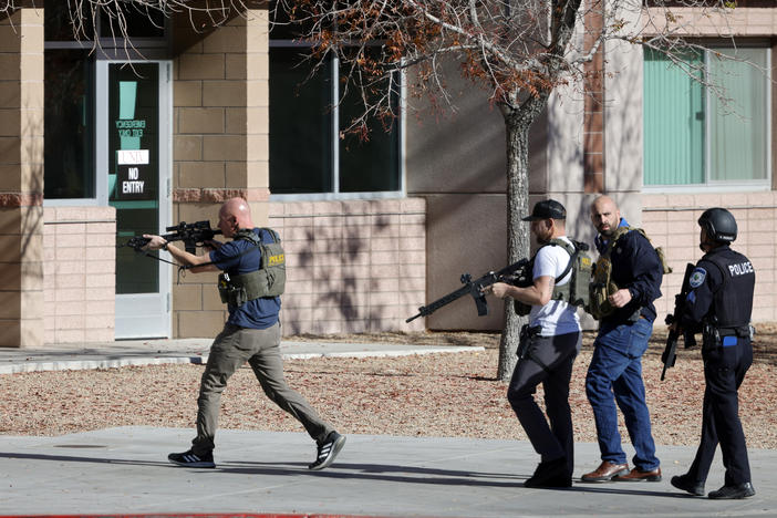 Law enforcement officers head into the University of Nevada, Las Vegas, campus after reports of an active shooter, Wednesday, Dec. 6, 2023, in Las Vegas.