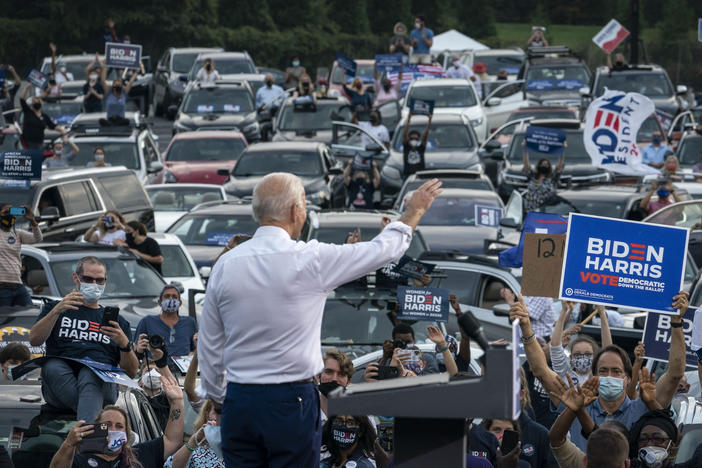 Then presidential candidate Joe Biden waves to supporters as he finishes speaking during a drive-in campaign rally in Georgia in 2020.