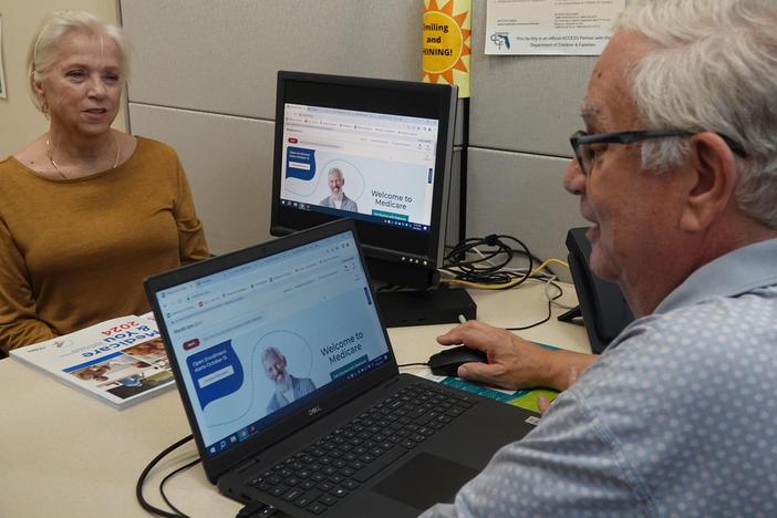 A counselor, right, navigates a client through the Medicare signup process at the Aging and Disability Resource Center of Broward County in Sunrise, Florida. Medicare open enrollment season ends Dec. 7.