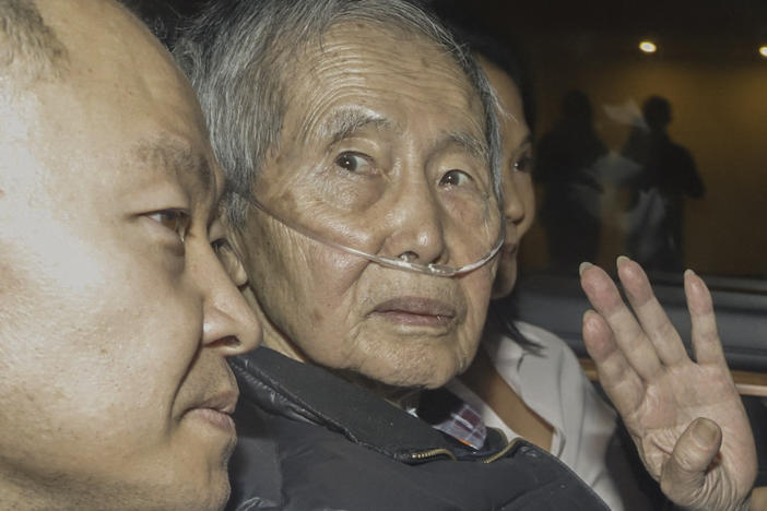 Former Peruvian President Alberto Fujimori sits between his children Kenji (left) and Keiko upon his release from the Barbadillo prison in the eastern outskirts of Lima, on Wednesday.