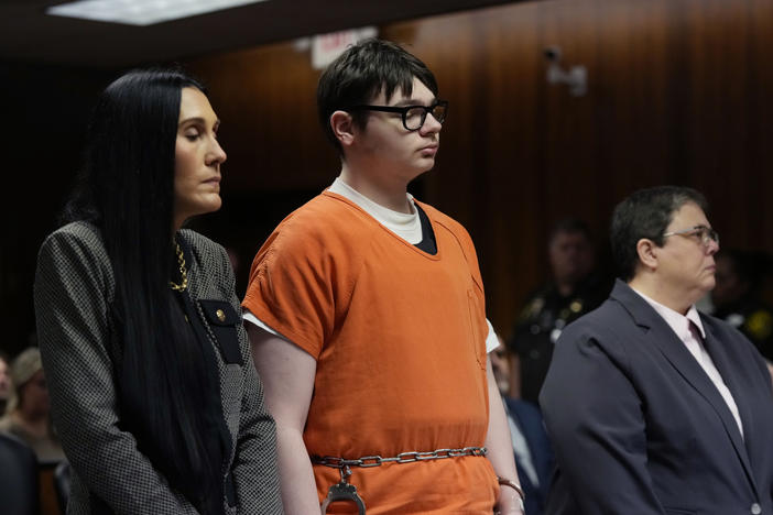 Ethan Crumbley stands with his attorneys Paulette Loftin (left) and Amy Hopp during his senencing hearing in Pontiac, Mich. Parents of students killed at Michigan's Oxford High School described the anguish of losing their children Friday as a judge considered whether Crumbley would serve a life sentence for the 2021 mass shooting.