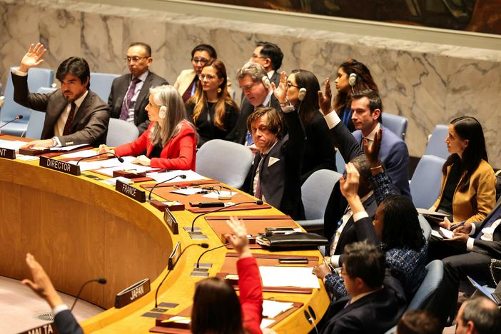 French Ambassador to the United Nations Nicolas de Rivière (center) and other representatives raise their hands in favor of a resolution calling for a cease-fire in Gaza during a U.N. Security Council meeting in New York on Friday. The U.S. vetoed it.