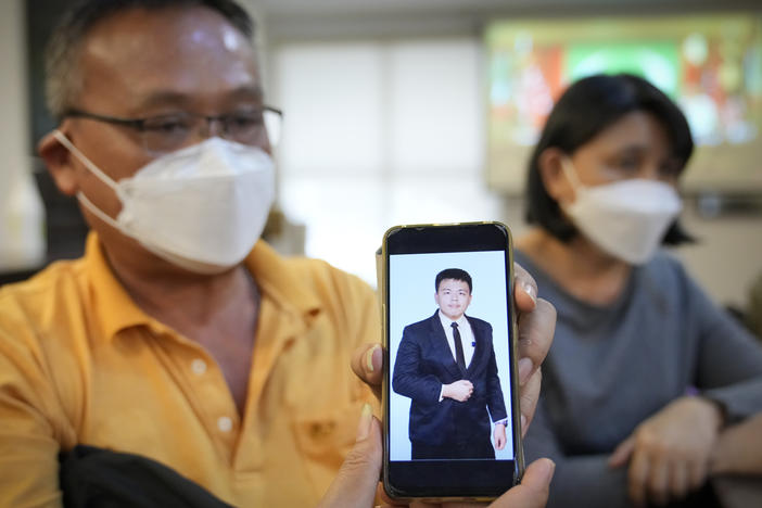 Goi Chee Kong shows a picture of his son Goi Zhen Feng, who died after falling prey to human trafficking, during a press conference in Petaling Jaya, Malaysia, on Sept. 21, 2022. Goi said he believed his 23-year-old son was forced to work for groups involved in online scams.