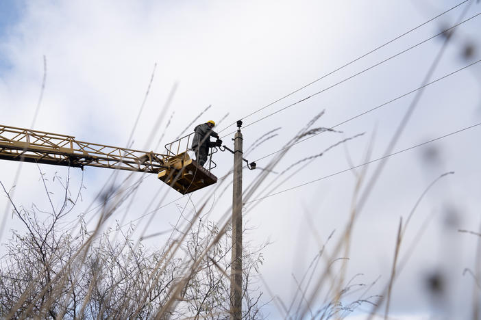 Utility workers north of Lyman, Ukraine, work on restringing electrical poles in an effort to brace the country's energy system against another winter of expected Russian attacks.