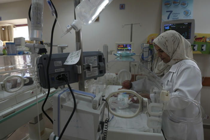 A Palestinian doctor treats a prematurely born baby at Al Aqsa Hospital in Gaza on Sunday, Dec. 10, 2023.