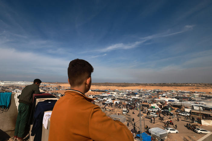 People look out from a rooftop last week as displaced Palestinians who fled Khan Younis in the southern Gaza Strip set up camp in Rafah, farther south, near Gaza's border with Egypt.