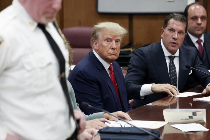Former President Donald Trump sits in the courtroom with his attorneys Joe Tacopina and Boris Epshteyn (right) during his arraignment at the Manhattan Criminal Court on April 4 in New York City.