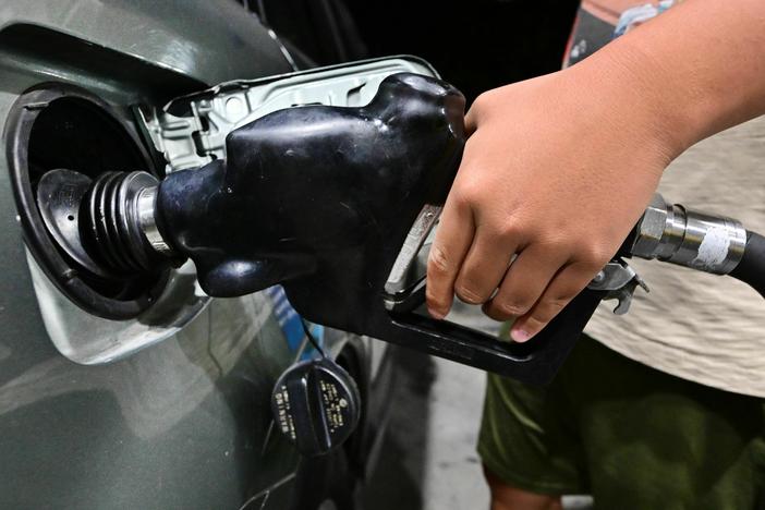 A man pumps gas in Alhambra, Calif., on Oct. 2, 2023.
