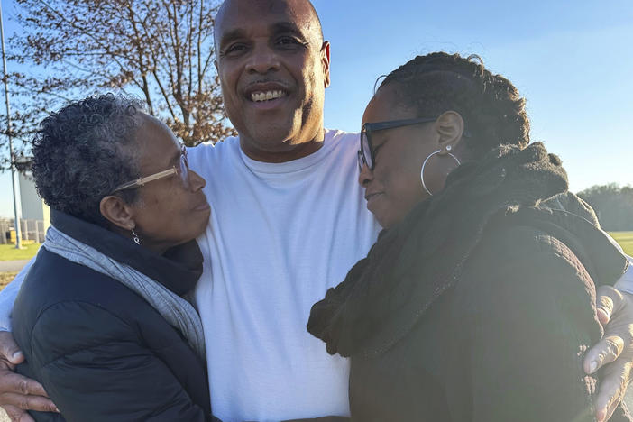 In this photo provided by Laura Nirider, Brian Beals, center, who was exonerated on a murder charge and released from a downstate prison after 35 years behind bars, hugs his sister Pattilyn Beals, left, and niece Tamiko Beals outside Robinson Correctional Institution, in Robinson, Ill., on Tuesday, Dec. 12, 2023.