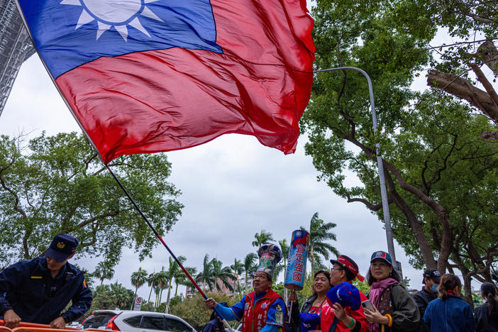 A supporter of Kuomintang, or KMT, Taiwan's major opposition party, waves Taiwan's national flag on Nov. 24, 2023, in Taipei, Taiwan. Researchers uncovered an influence operation targeting Taiwan's upcoming presidential election on Facebook, TikTok and YouTube.
