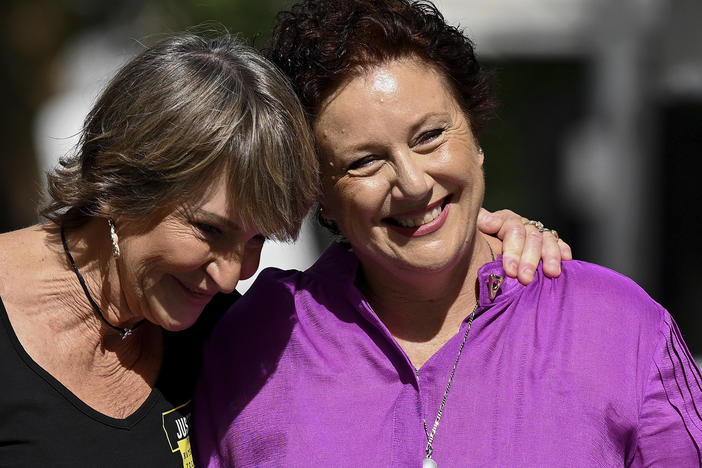 Kathleen Folbigg, right, is embraced by friend Tracy Chapman outside the New South Wales Court of Criminal Appeal in Sydney, Australia, Thursday, Dec. 14, 2023.