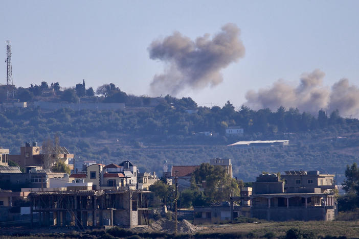 A picture taken from from the southern Lebanese village of Tayr Harfa, near the border with Israel, shows smoke billowing near an Israeli outpost from rockets fired by Hezbollah on Dec. 15.