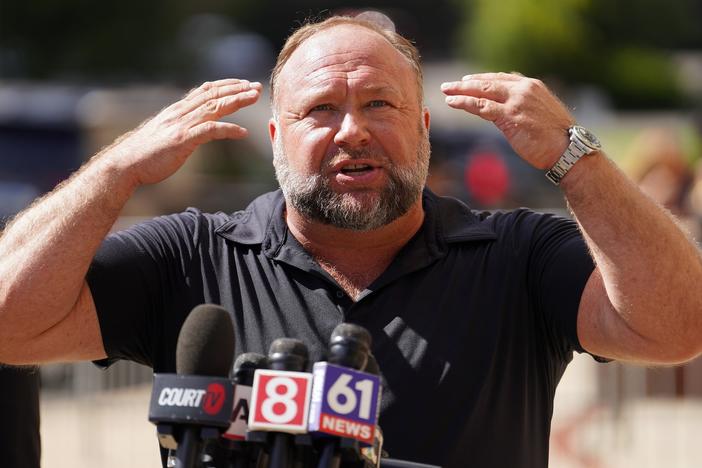 InfoWars founder Alex Jones speaks to the media outside Waterbury Superior Court during his trial on Sept. 21, 2022 in Waterbury, Conn.