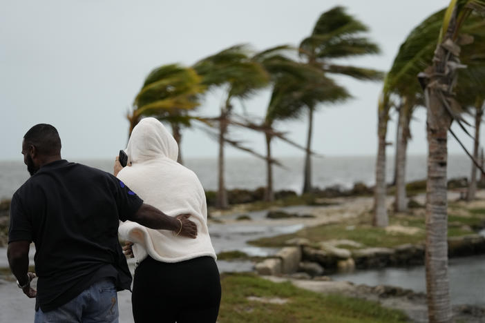 Local resident Wayne Cox and friend Irma Parrilla, visiting from Orlando, brave gusty winds and drizzling rain to visit Matheson Hammock Park in Coral Gables, Fla., on Friday.