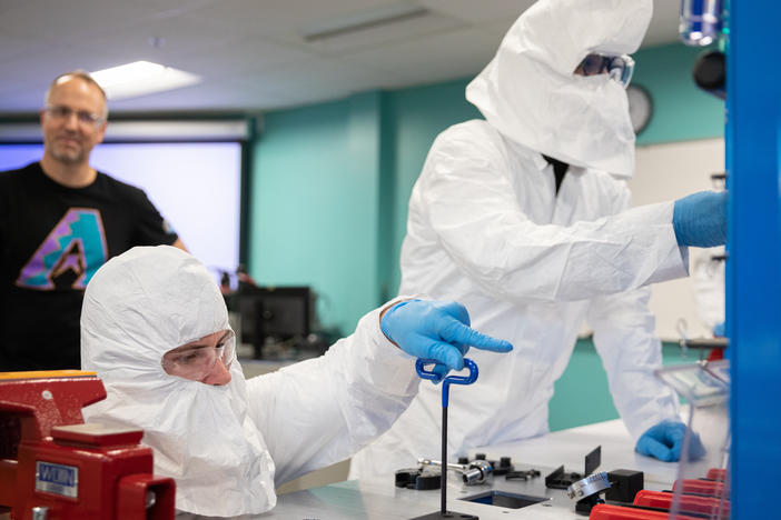 Brad Gist, 30, works with Liam Levinson, 28, during a lab for a 10-day semiconductor course at Chandler Gilbert Community College in Mesa, Ariz., on Oct. 11, 2023.