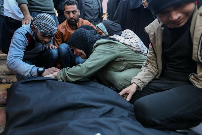 People mourn as they collect the bodies of Palestinians killed in an airstrike on Monday in Khan Yunis, Gaza. The United Kingdom, France and Germany are the latest countries to call on Israel to reach a "sustainable truce" after more than two months of war in Gaza.