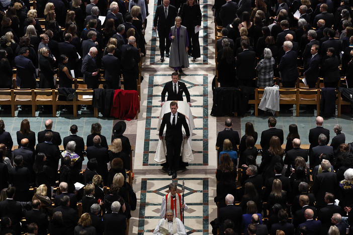 Supreme Court Justice Sandra Day O'Connor's casket is wheeled out of Washington National Cathedral at the conclusion of her funeral.