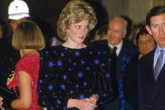 The Prince and Princess of Wales attend a dinner held by the Mayor of Florence during a tour of Italy, April 1985. The Princess wears a dress by Jacques Azagury.