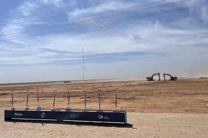 Shovels and an excavator are visible at the groundbreaking celebration for the Stratos direct air capture plant in West Texas on April 28. Construction began on the site in late 2022, and it's slated to begin operations in 2025.